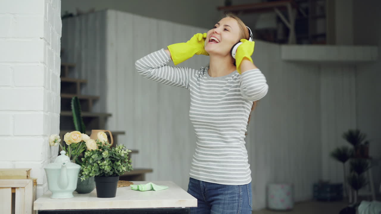 Woman Cleaning Her Home While Dancing to Music