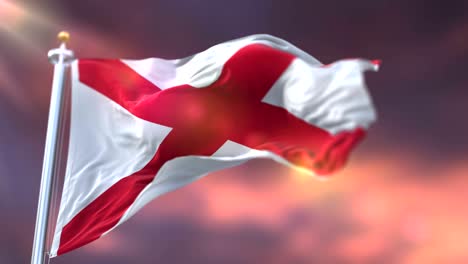 bandera del estado de alabama, región de los estados unidos, ondeando al atardecer - bucle