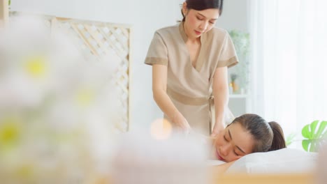 woman receiving a back massage at a spa