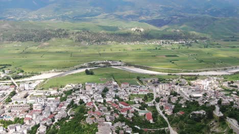 Drone-view-in-Albania-flying-in-Gjirokaster-over-a-medieval-town-showing-the-brick-brown-roof-houses