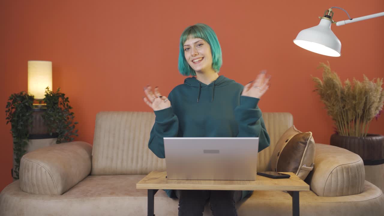 The young woman waving at the camera.