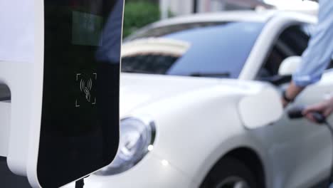 progressive man pay for charging point to power rechargeable electric vehicle.