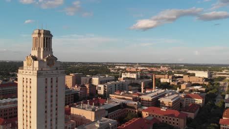 Aerial-Drone-shot-of-the-tower-on-UT-campus-that-slowly-pans-towards-the-football-stadium