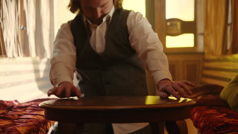 man reaching for table in vintage train car
