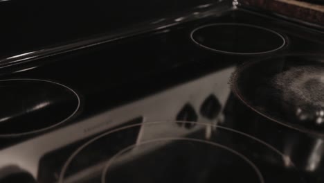 An-Elegant-Black-Freestanding-Electric-Induction-Convection-Range-Kitchen-Appliance---Close-Up-Shot