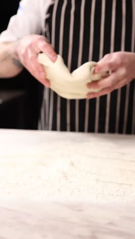 chef kneading dough