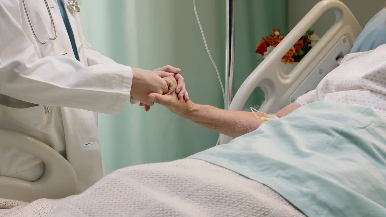 médico sosteniendo la mano de una anciana en la cama del hospital consolando a un paciente anciano hospitalizado recuperándose de una enfermedad profesional médico al lado de la cama dando aliento apoyo de atención médica