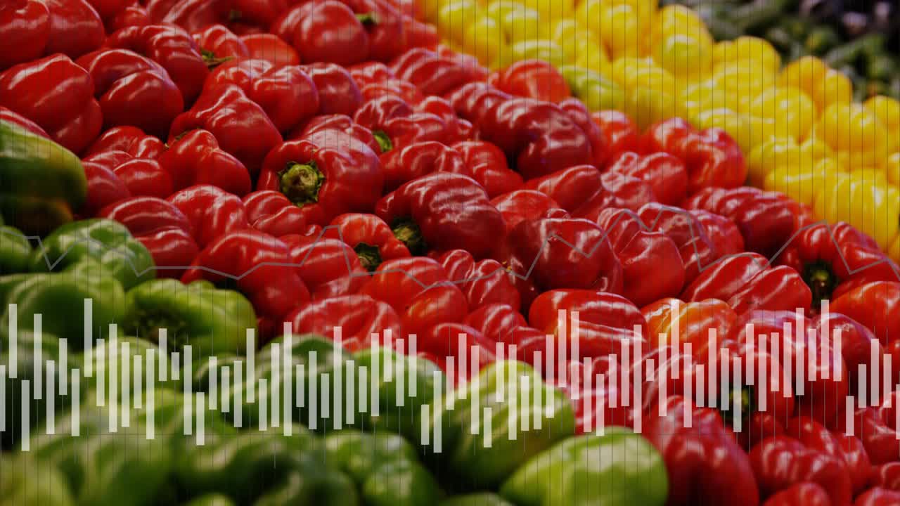 Audio driving waveform motion over stacked bell peppers while camera shifting focus to show colors