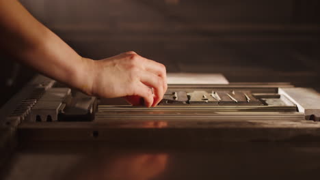 hand setting type on a vintage letterpress