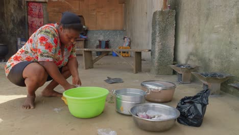 african lady working in outdoor village kitchen preparing tasting fufu traditional ghana street food