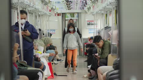 people wearing masks on a train