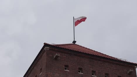 polish flag on wawel royal castle in krakow, poland