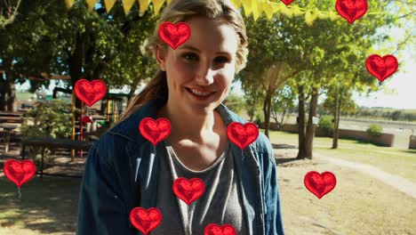 animation of hearts over happy caucasian mother with children in park