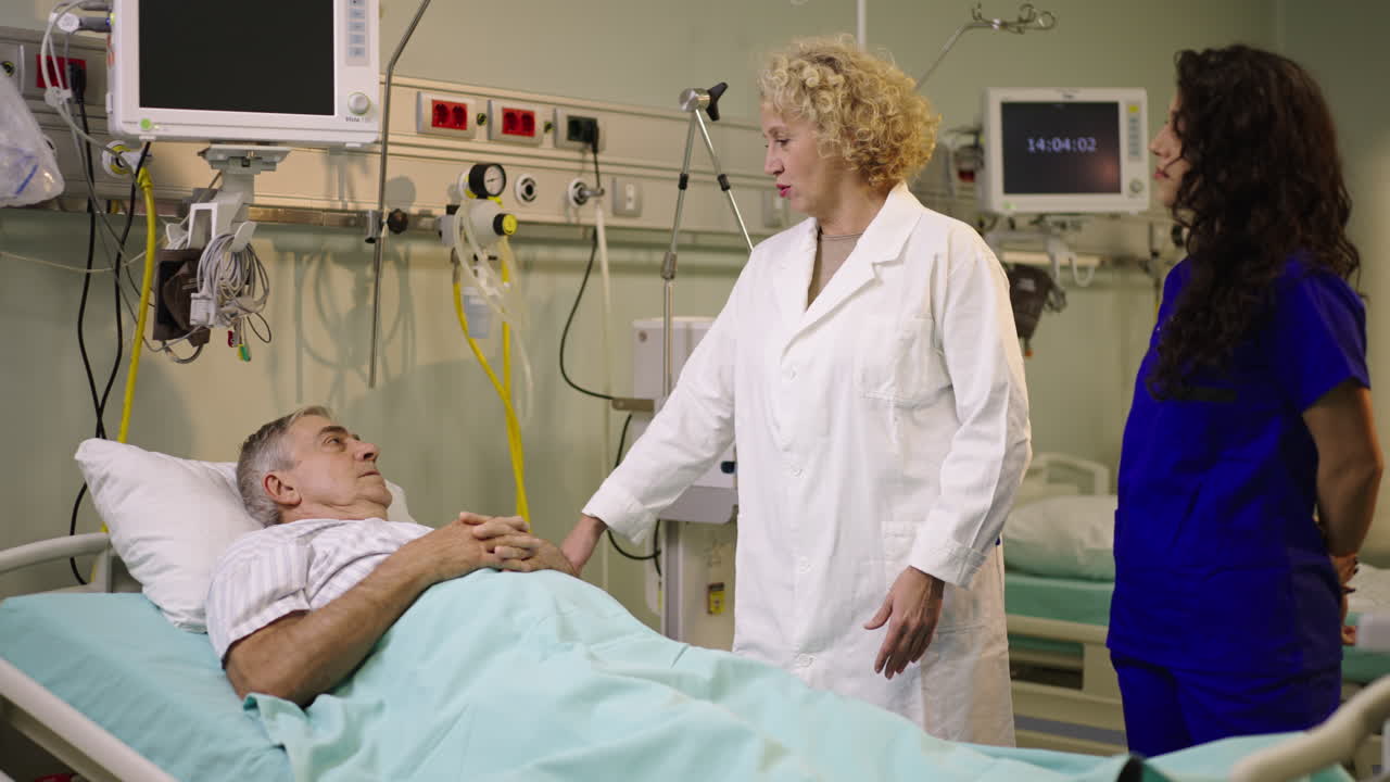 Healthcare professionals attending to a patient in a hospital bed