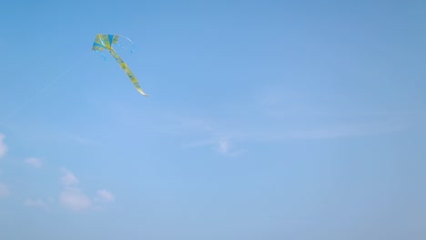 happy young couple in love flying a kite. young couple in love running with a kite in a yellow field
