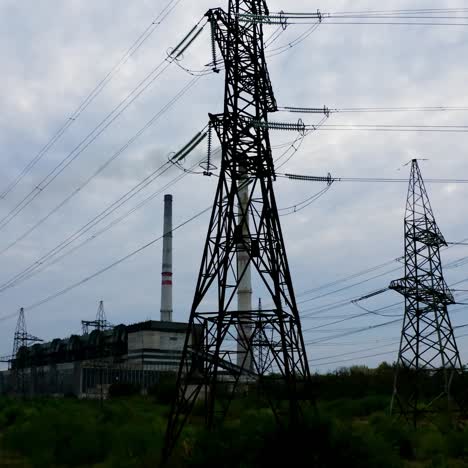 high voltage post. high voltage pylons against sunset background. energy and industrialisation concept. selective focus