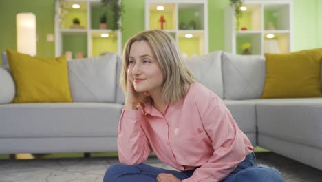young girl at home daydreaming.