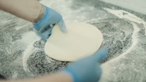 chef baker cook pizza. closeup hand of chef baker making pizza at kitchen