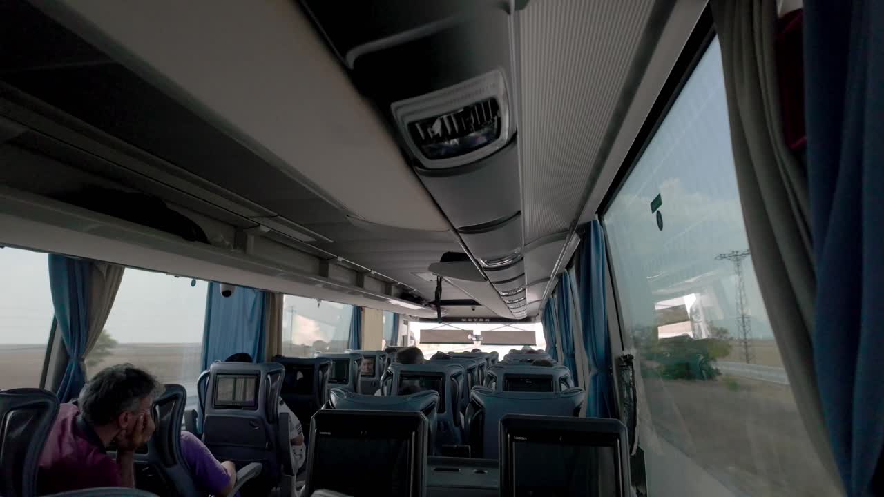 Interior view of a bus as it travels from Ankara to Konya, showcasing passenger seats and windows