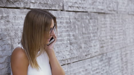 excited woman talking by cell phone