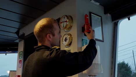 capitán de buque probando el transpondedor de radar de emergencia sart, cabina del timón