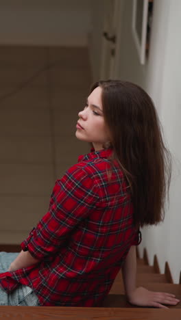 woman tired after work rests on hall steps. lady with negative emotions expression overthinks potential problems on staircase. mental health support