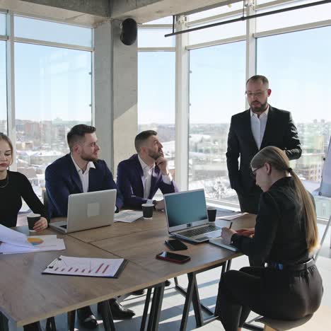 team meeting in the spacious office. business discussion and brainstorming with collegues. coworkers of both genders having a meeting in the office