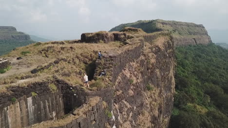 adventurous tourists explore ancient vinchu kada fort hill station