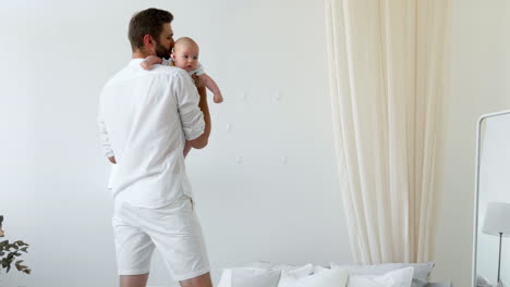 unrecognizable father caressing crying newborn baby son