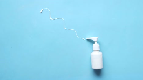 white bottle of lotion or cream with squeezed liquid