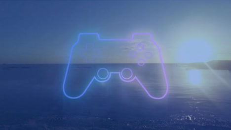 Videogame-controller-icon-against-view-of-sunset-sky-over-the-sea