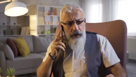 Self-employed-Mature-Man-With-Beard-Gets-Bad-News-On-The-Phone.