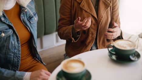 two women at a cafe having coffee