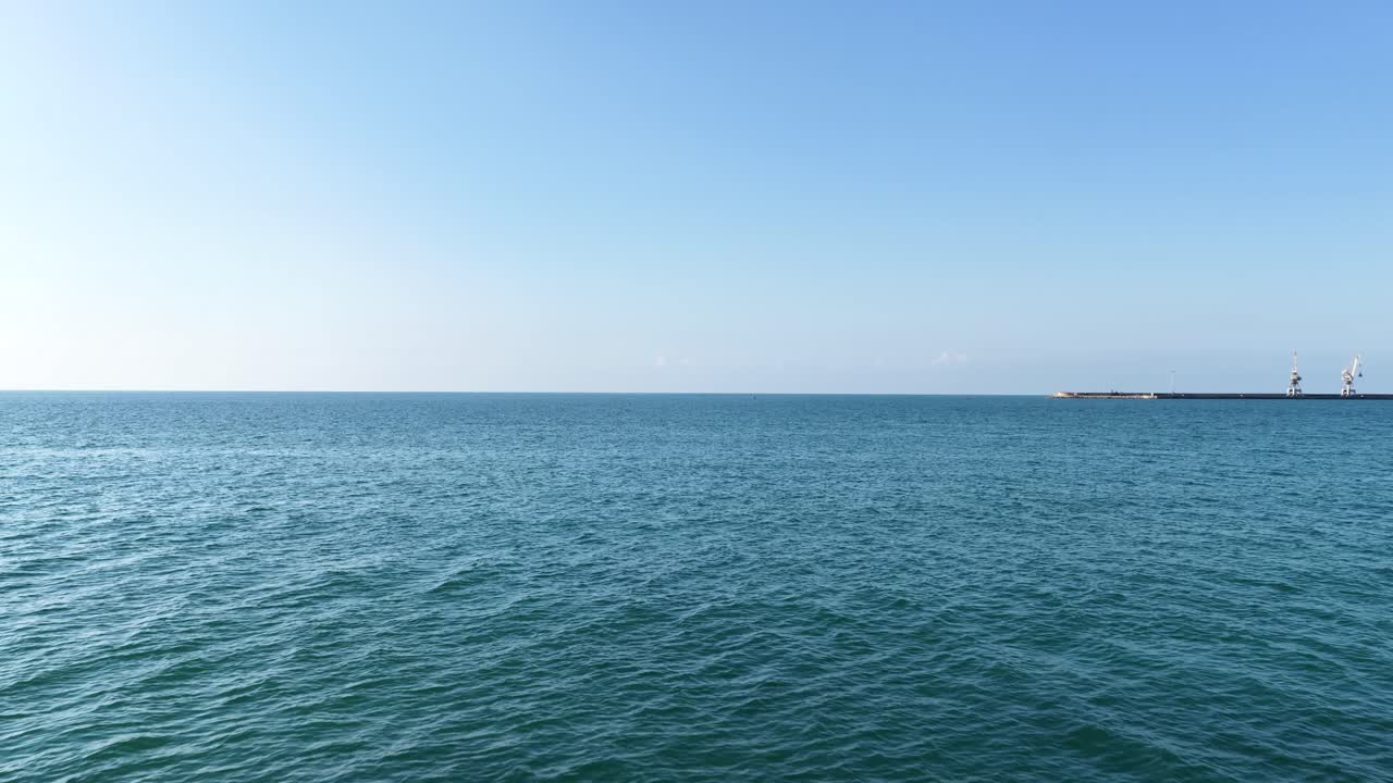 Athlete paddle boarding on calm sea near pier