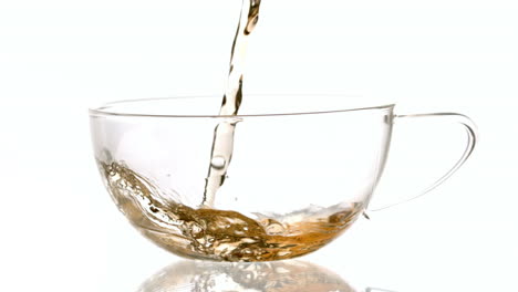 Hot-tea-pouring-into-glass-cup