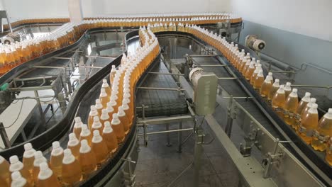 conveyor belt with bottles for juice or water at a modern beverage plant. modern production of sweet soda water