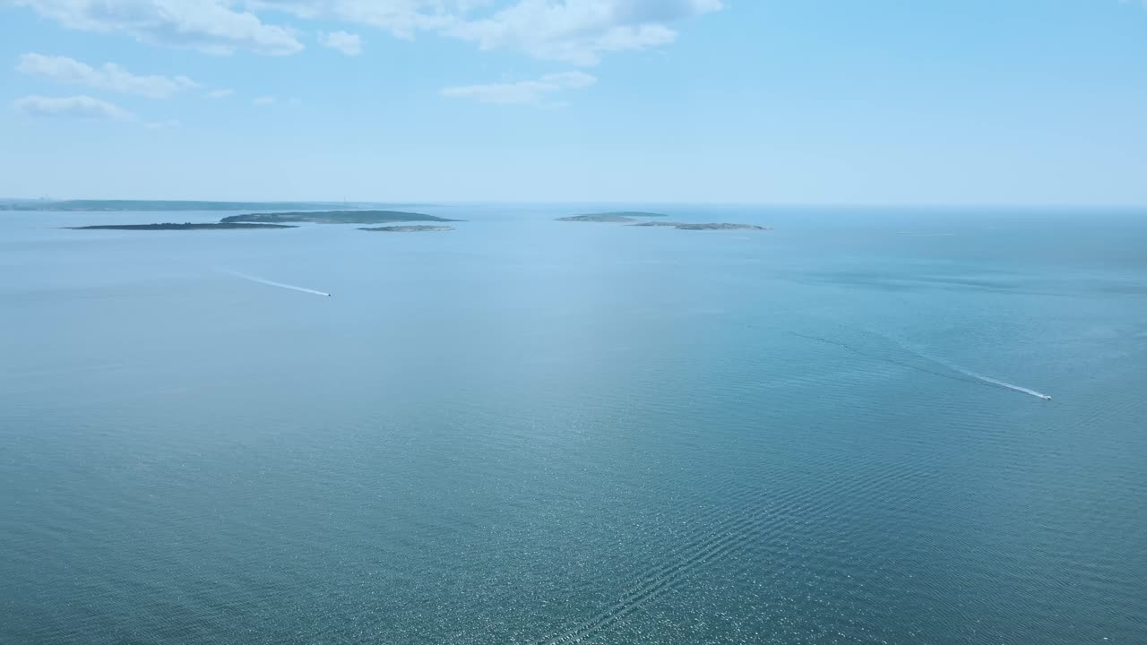 Distant View Of The Boats Sailing On The Blue Ocean Of Asa Beach In Southern Gothenburg, Halland, Sweden. aerial