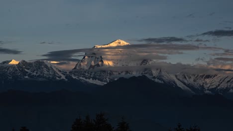 sunrise himalayas mountains timelapse in nepal, time lapse of snowcapped mountain range at sunrise with clouds moving in beautiful golden orange light, beautiful snow covered winter summits