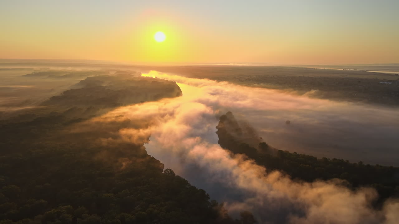Aerial drone view of nature of Moldova at sunset. River and lush fog above it, greenery