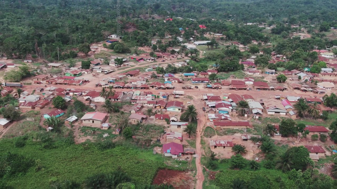 Wide aerial drone shot of Toetown in Grand Gedeh County, Liberia on a sunny day