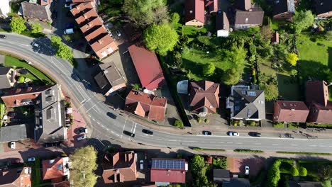 cars on curvy street during sunny in american town. sunny day in spring. aerial top down flyover. red roof townhouses in usa.
