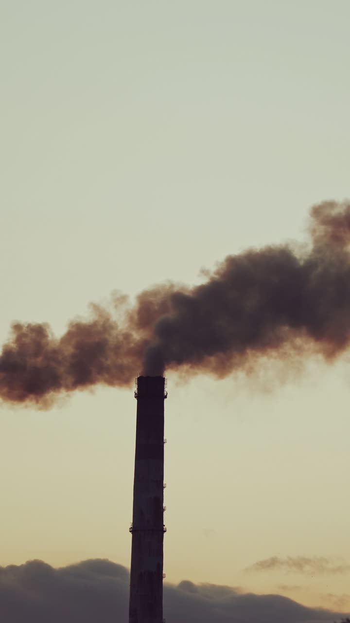 Dioxide air contamination. industrial smoke from chimney against sunset