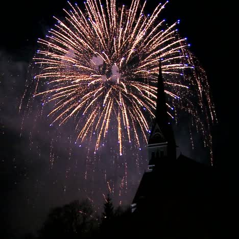 a magnificent fireworks display behind a church