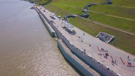 newly wedded couple walks along embankment bird eye view