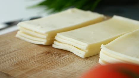 sliced cheese on a cutting board