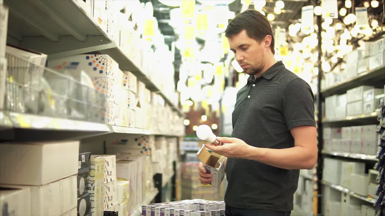 hombre comprando bombillas en una ferretería