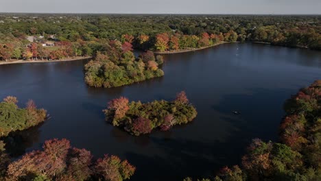 An-aerial-view-of-Belmont-State-Park-on-Long-Island,-NY-on-a-sunny-day-with-beautiful-fall-foliage