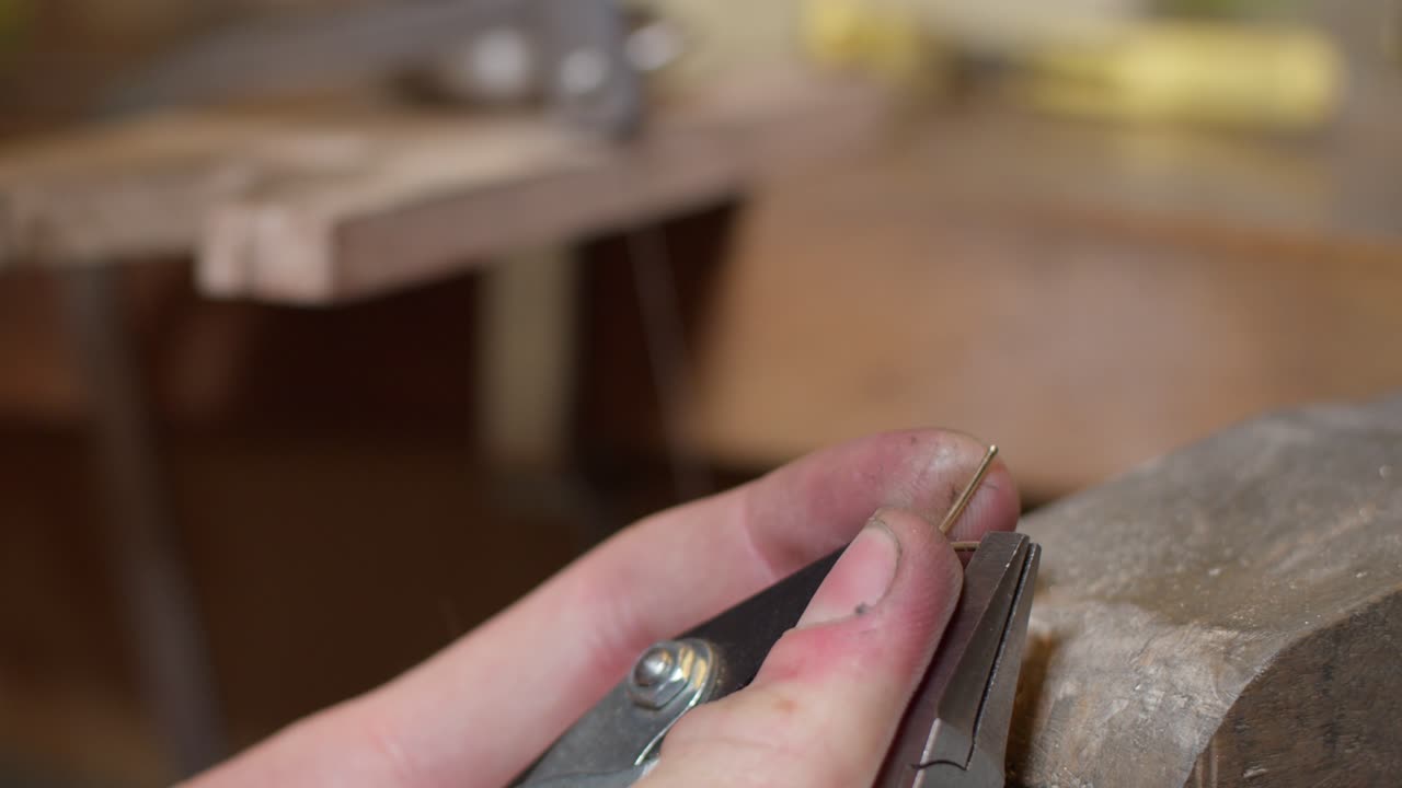 jeweller crafting cold ring in workshop