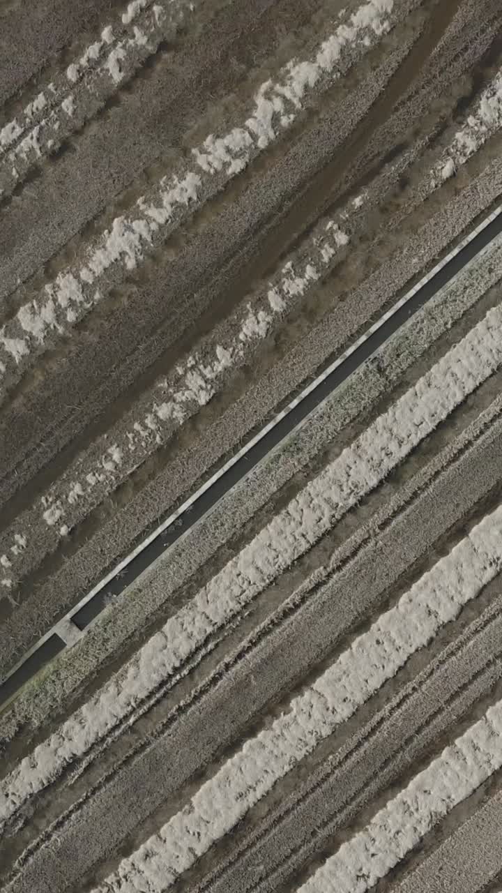 Aerial Drone View of Residential Area with Canal, Houses, and Rural Surroundings