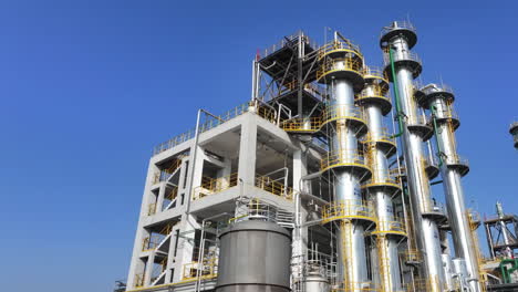 petrochemical factory industrial storage steel tanks buildings and complex piping equipment in oil gas refinery industry plant under blue sky